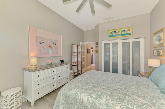 bedroom featuring a ceiling fan, visible vents, and light wood-style flooring