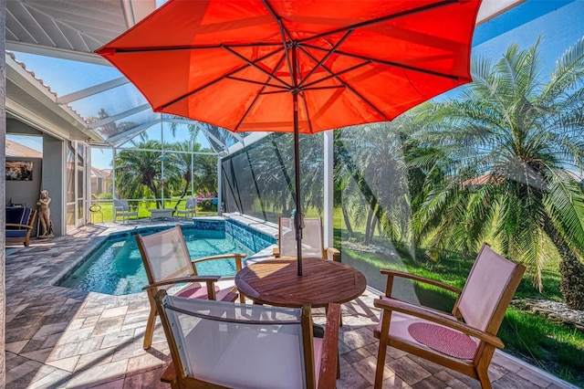 outdoor pool with glass enclosure and a patio