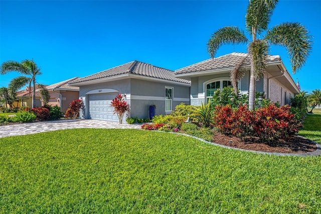 view of front of home with a front yard, decorative driveway, an attached garage, and stucco siding