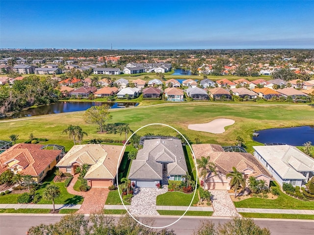 birds eye view of property with a water view, a residential view, and golf course view