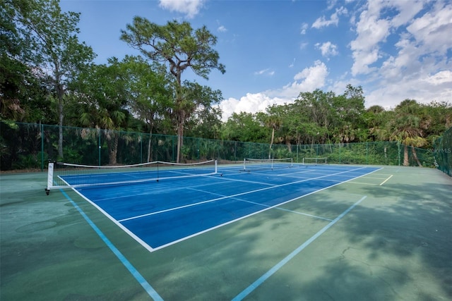 view of sport court featuring fence