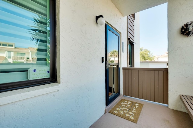 view of exterior entry featuring stucco siding