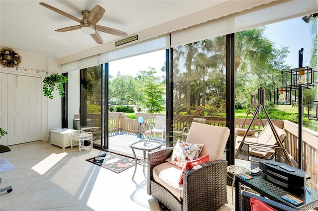 sunroom featuring a ceiling fan