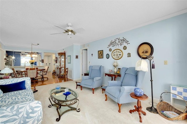 living room with crown molding and a ceiling fan