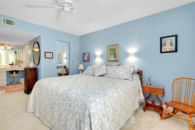 carpeted bedroom featuring visible vents, a closet, and ceiling fan