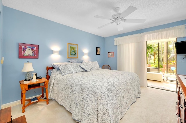 bedroom featuring a textured ceiling, ceiling fan, baseboards, and light carpet