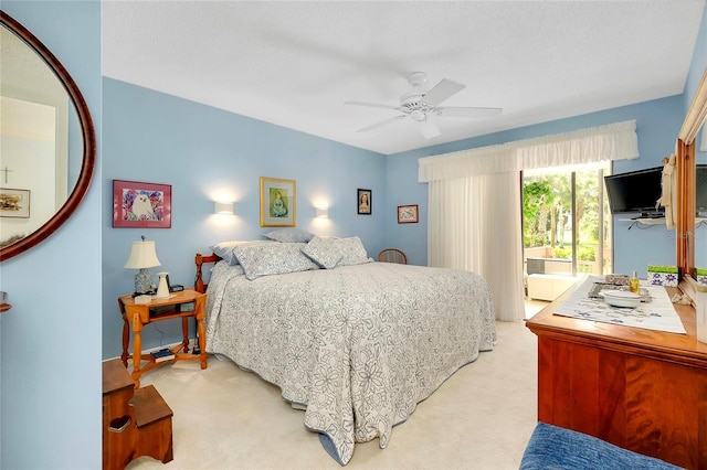 bedroom featuring light carpet and a ceiling fan