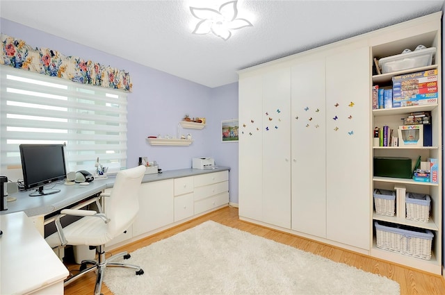 office featuring a textured ceiling and light wood finished floors