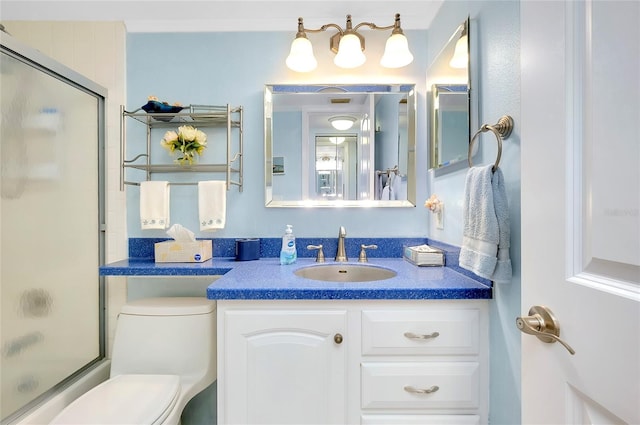 full bathroom featuring combined bath / shower with glass door, toilet, and vanity