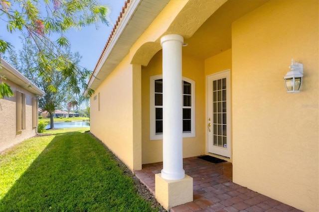 view of property exterior featuring a patio area, a lawn, and stucco siding