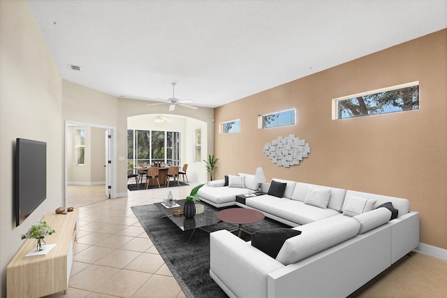 living room featuring light tile patterned floors, baseboards, visible vents, and a ceiling fan