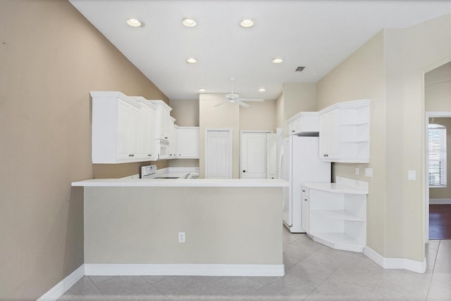 kitchen with a peninsula, white appliances, visible vents, and open shelves