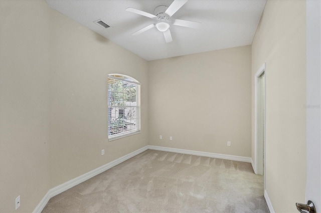 empty room featuring ceiling fan, baseboards, visible vents, and light colored carpet