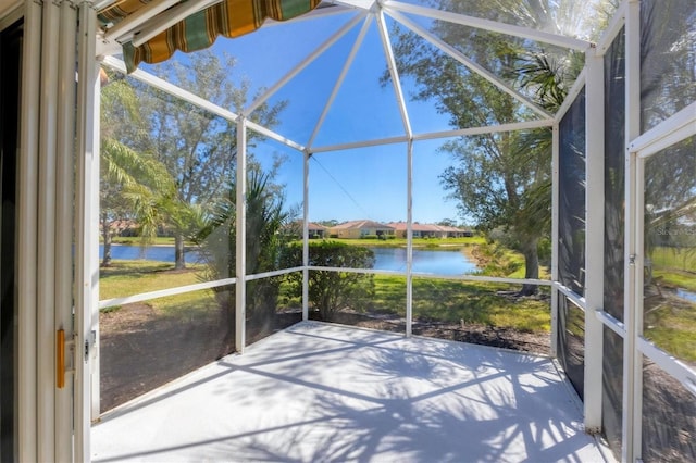 unfurnished sunroom with a water view