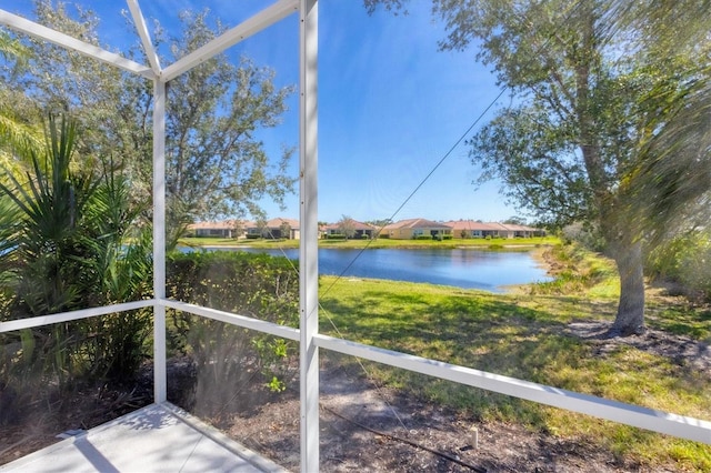 unfurnished sunroom with a water view