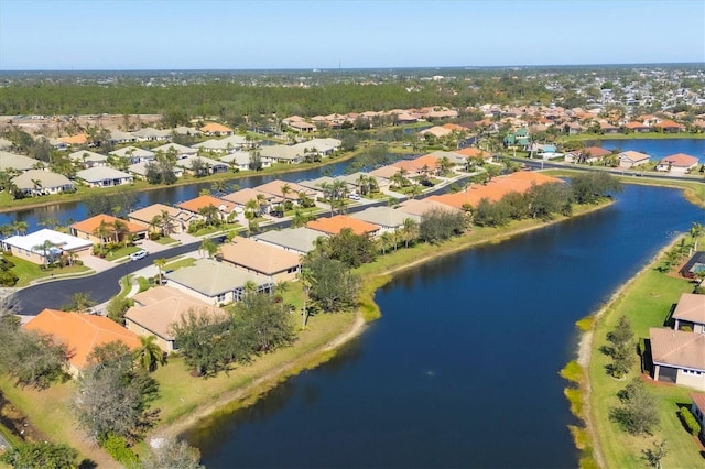 drone / aerial view with a water view and a residential view