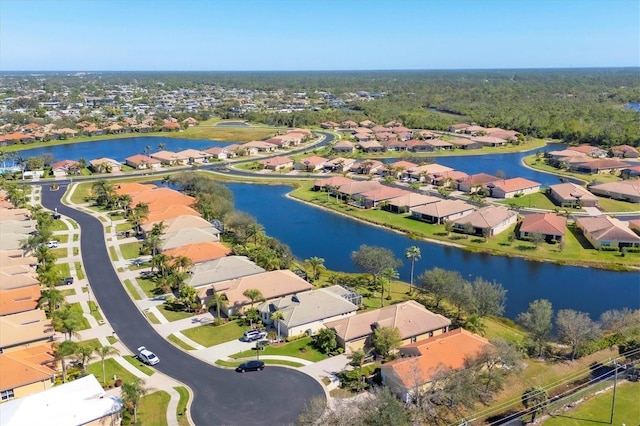 drone / aerial view with a water view and a residential view