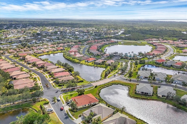 drone / aerial view with a water view and a residential view