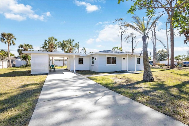 ranch-style home with a carport, driveway, and a front lawn