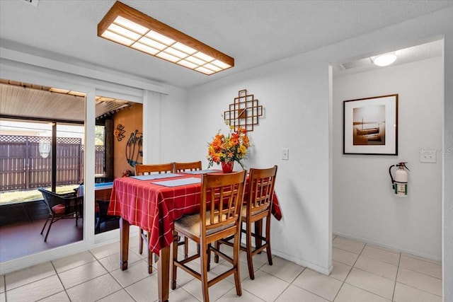 dining area featuring tile patterned flooring and baseboards