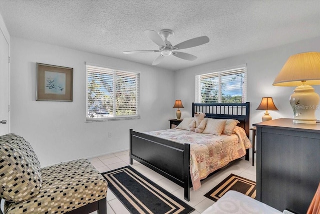 bedroom featuring light tile patterned floors, a textured ceiling, and a ceiling fan