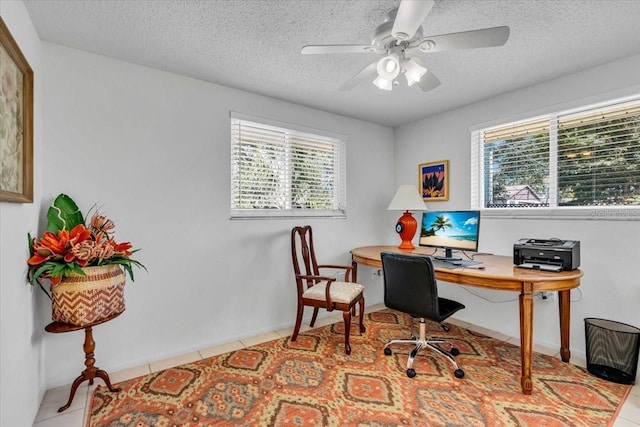 tiled office featuring a textured ceiling and a ceiling fan