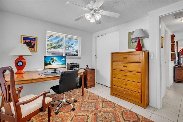 home office with ceiling fan, a textured ceiling, and light tile patterned flooring