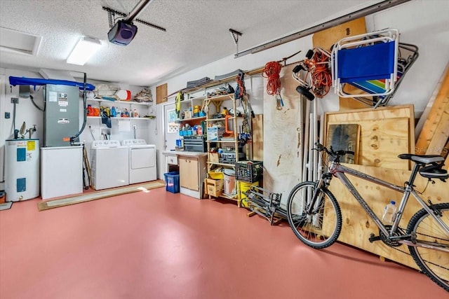 garage featuring water heater, a garage door opener, and independent washer and dryer