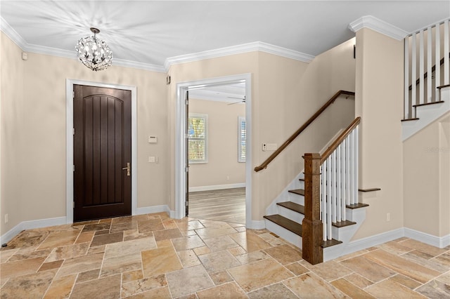 entrance foyer with baseboards, stairs, ornamental molding, stone tile flooring, and an inviting chandelier