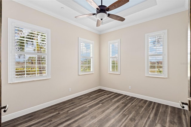 spare room featuring ornamental molding, dark wood-style flooring, baseboards, and a ceiling fan