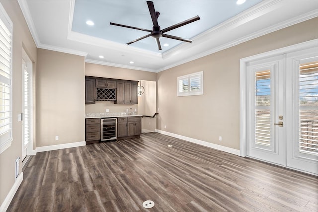 bar with wine cooler, french doors, wet bar, dark wood-style floors, and a tray ceiling