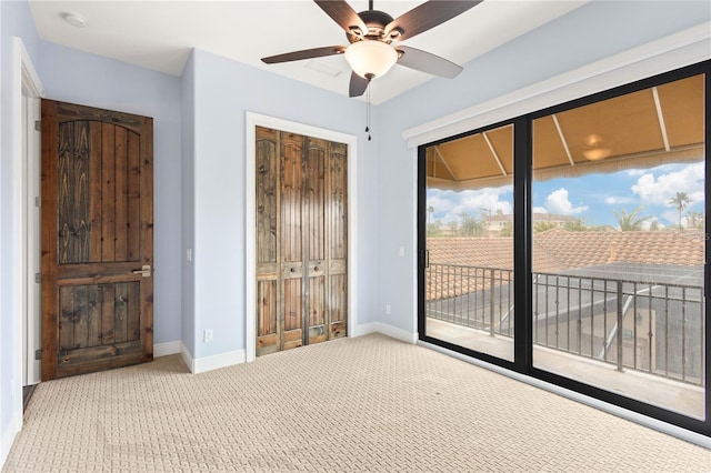 unfurnished bedroom featuring access to exterior, a closet, baseboards, and carpet flooring