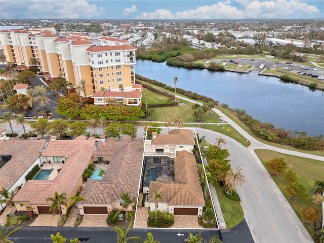 birds eye view of property with a water view and a residential view