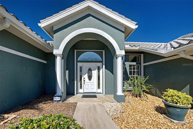 doorway to property with stucco siding