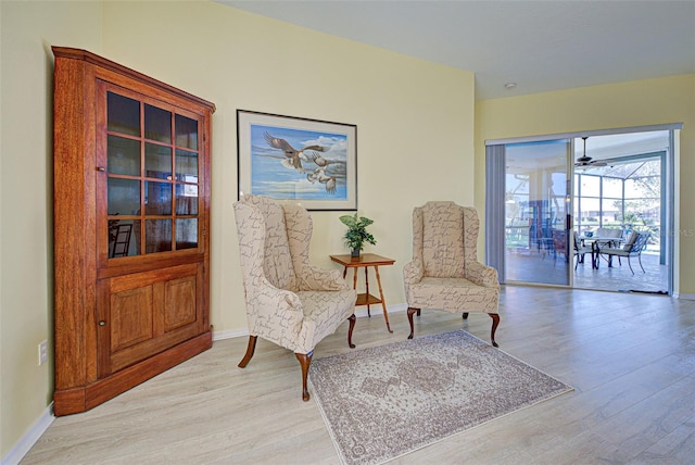 sitting room featuring light wood finished floors and baseboards