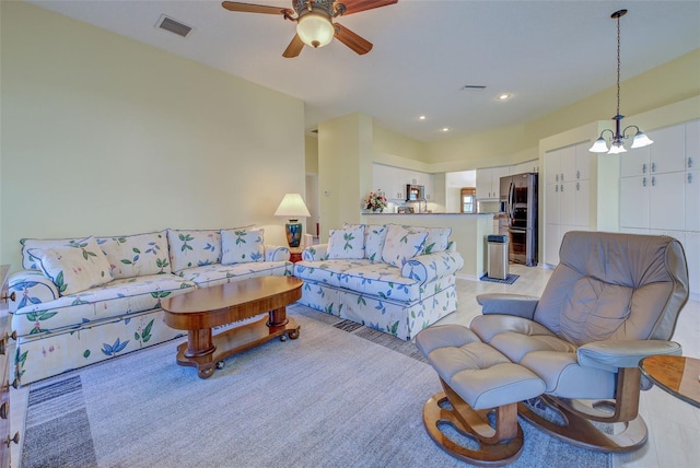 living room with recessed lighting, visible vents, and ceiling fan with notable chandelier