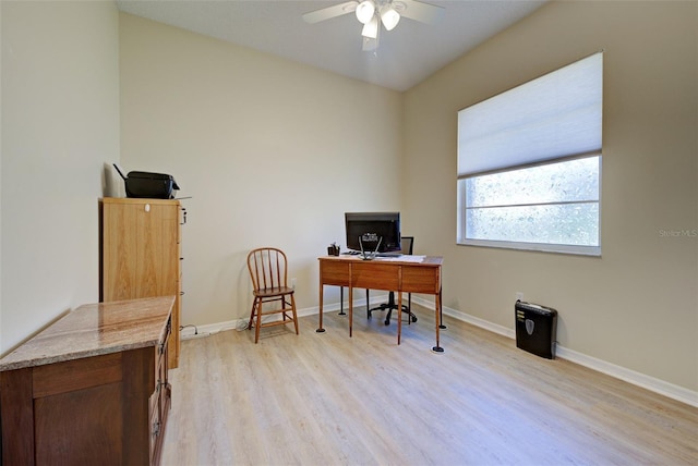 office area with light wood-style flooring, baseboards, and ceiling fan