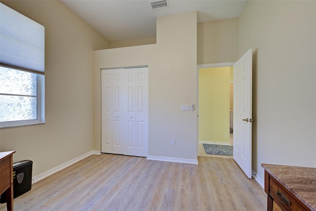 unfurnished bedroom featuring light wood-type flooring, visible vents, and baseboards