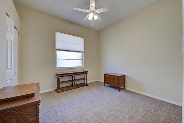 interior space with carpet floors, baseboards, and a ceiling fan