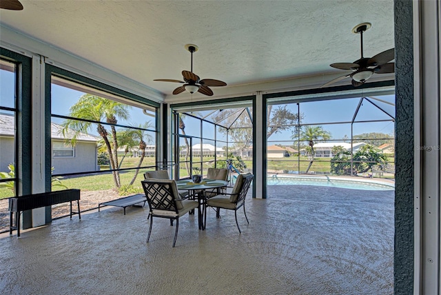 sunroom / solarium with a ceiling fan