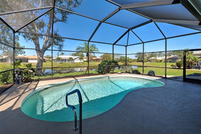 pool with a water view, glass enclosure, a patio area, and a lawn