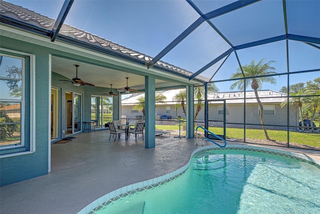 outdoor pool featuring glass enclosure, a patio area, and a ceiling fan