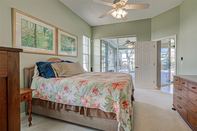 bedroom featuring access to outside, a ceiling fan, a textured ceiling, and light colored carpet