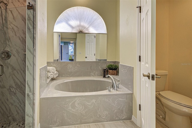 full bath featuring a garden tub, a shower stall, and toilet