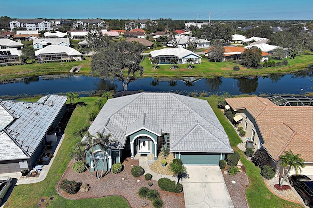 drone / aerial view featuring a water view and a residential view