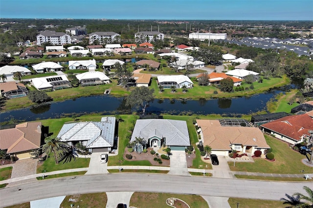 drone / aerial view with a water view and a residential view