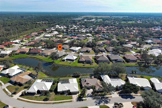 birds eye view of property featuring a water view and a residential view