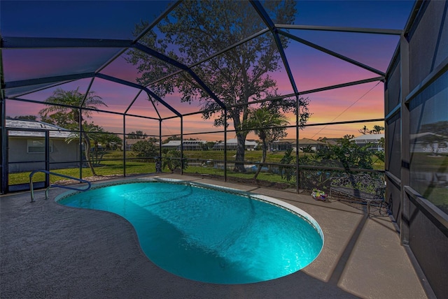 pool with glass enclosure and a patio area