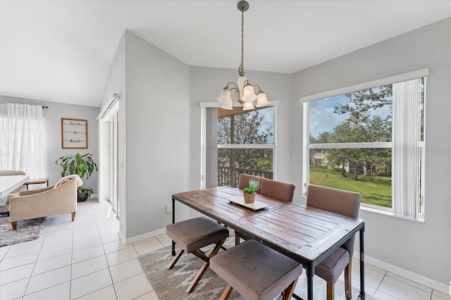 dining space with light tile patterned floors, baseboards, and a chandelier