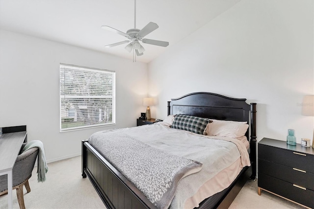 bedroom with light carpet, baseboards, a ceiling fan, and lofted ceiling